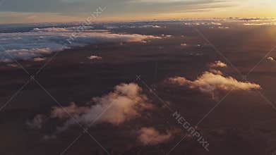 Aerial View of Sunset Over Expansive Cloudscape with Distant Horizon Lighting