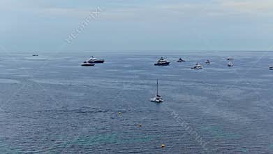 Aerial drone view of luxury superyachts anchored i