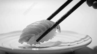Monochrome Close Up of Picking Up Nigiri Sushi with Chopsticks