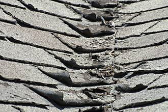 Old Bad and Curling Roof Shingles on a House or Home
