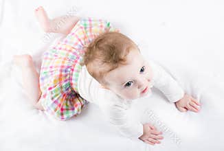 Beautiful baby girl trying to crawl