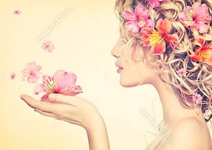 Girl takes beautiful flowers in her hands