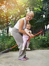 Woman is playing witches with her litle granddaugh
