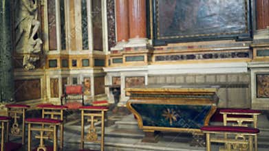 Ornate church interior with defocused altar, carved statue and red velvet kneelers, soft blurred depth; background backplate
