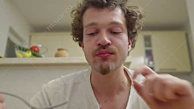 Young Man Enjoys Delicious Home Meal in Kitchen, Featuring Eating Sounds