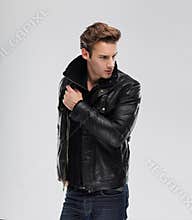 Fashion man, model leather jacket, gray background