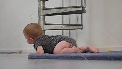 An adorable baby crawling indoors