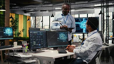 Smiling programmers working in AI startup train predictive models