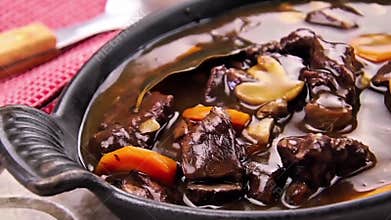 Hearty Beef Stew in Rustic Bowl with Carrots and Mushrooms