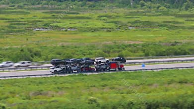 Auto hauler truck carrying new and used cars on multi-level trailer as part of nationwide vehicle distribution.