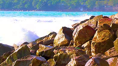 Tropical turquoise clear water waves rocks Patong Beach Phuket Thailand