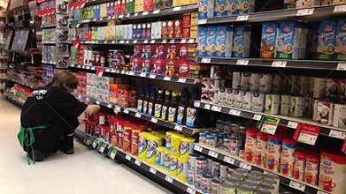 Worker restocking the hot chocolate in the shelf