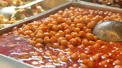 Enjoying warm chickpeas in sauce at the local market