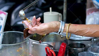 put the Eastern sauce in a plastic bag atmosphere of the market selling cakes, food, and drinks for breaking the fast or