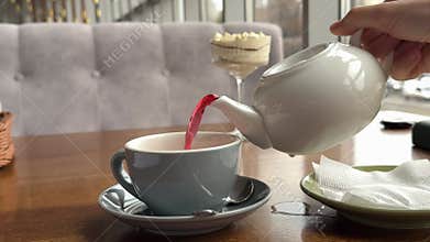 hibiscus tea Glass cup of hot hibiscus tea and dried Hibiscus tea leaves.