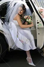 Bride exiting wedding car limo