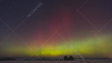 Bright northern lights dance over icy fields under starlit sky, Spectacular display of green and red auroras shimmering over
