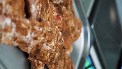 Marinated pork ribs with BBQ spices on tray. Raw meat prepared for grilling in