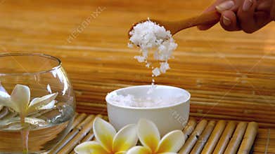Salt scrub pouring into bowl at the spa