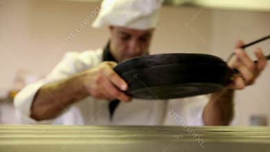 Handsome chef wiping down the counter