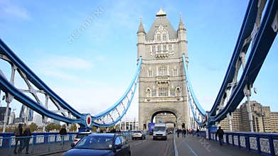 A London red bus crosses Tower Bridge