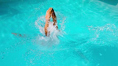 Athletic swimmer diving into the pool