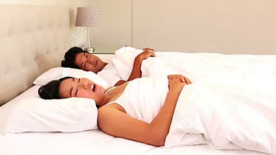 Man covering his ears to block out snoring