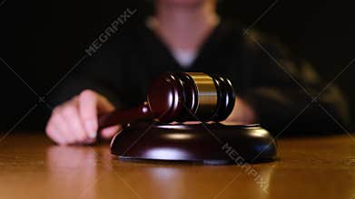 Female judge hitting a gavel in courtroom