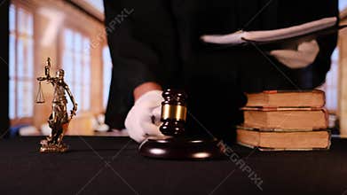 Judge in courtroom striking gavel for verdict