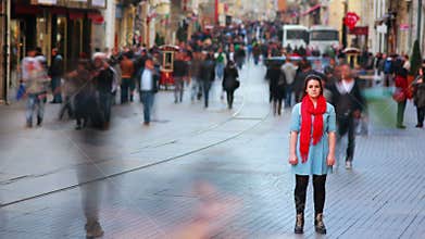 Young woman posing, busy street, people walking around, HD