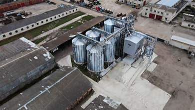 Aerial view of a modern grain silo complex and agro-industrial elevator facility on a farm with surrounding fields