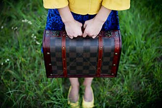 Girl holding retro vintage suitcase, travel concept, change and move concept