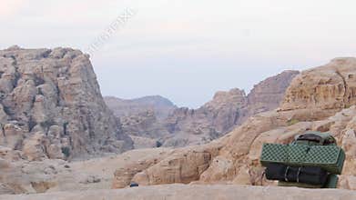Backpacking gear and sleeping pad on Petra canyon viewpoint Jordan Trail remote desert mountains wilderness camping adventure