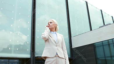 Serious businesswoman with smartphone outdoors