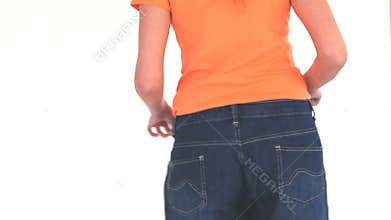 Woman happy to have lost weight showing her pants