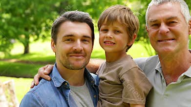 Three generations of men smiling at camera