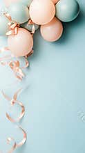 Pastel balloons and flowing ribbons against a soft blue background for a festive celebration