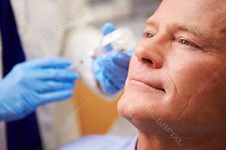 Man Having Botox Treatment At Beauty Clinic