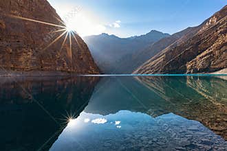 Sun rising over an turquoise color large alpine lake in Ladakh, Himalayas mountains, India