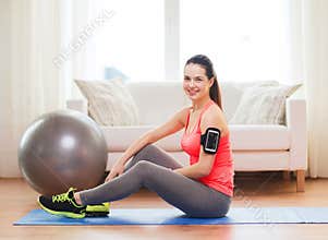 Smiling girl with armband execising at home