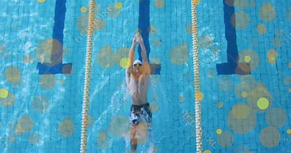 Male swimmer crouching on block then diving at animated start cue and racing backstroke
