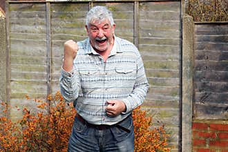 Elderly man celebrating his achievement .