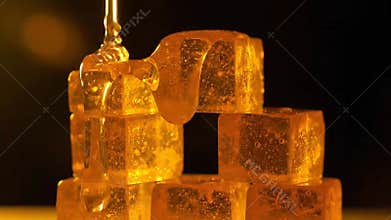 Macro Shot of Honey Cubes Stack with Dripping Liquid Gold Syrup on Dark Backdrop Transparent Golden Cubes Syrup Cascade Sweet
