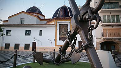 Anchor monument beside the blue domes of Iglesia de San Jaim