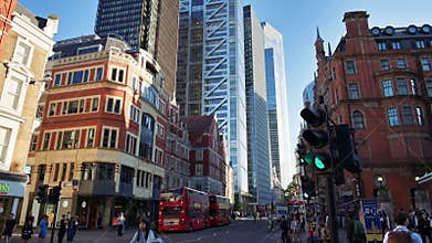 London, England - May 13, 2025: Red double-decker buses pass