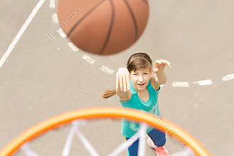 Attractive girl shooting a basketball