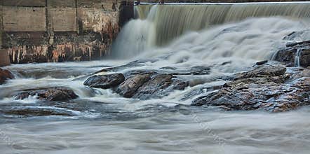 Photo of the waterfalls next to the building and at the top of the Mont-Laurier dam located in the city, in Quebec, Canada