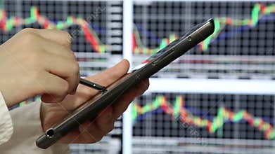 Woman checking stock on tablet pc