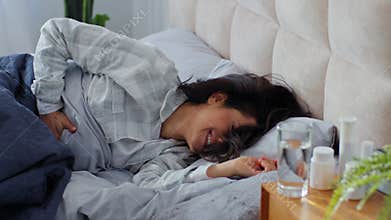 Caucasian woman waking up in morning suffering belly paIn ache menstrual spasm discomfort painful cramp stomach aching