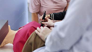 Child learning basic medical skills doing ultrasound simulation on training mannequin